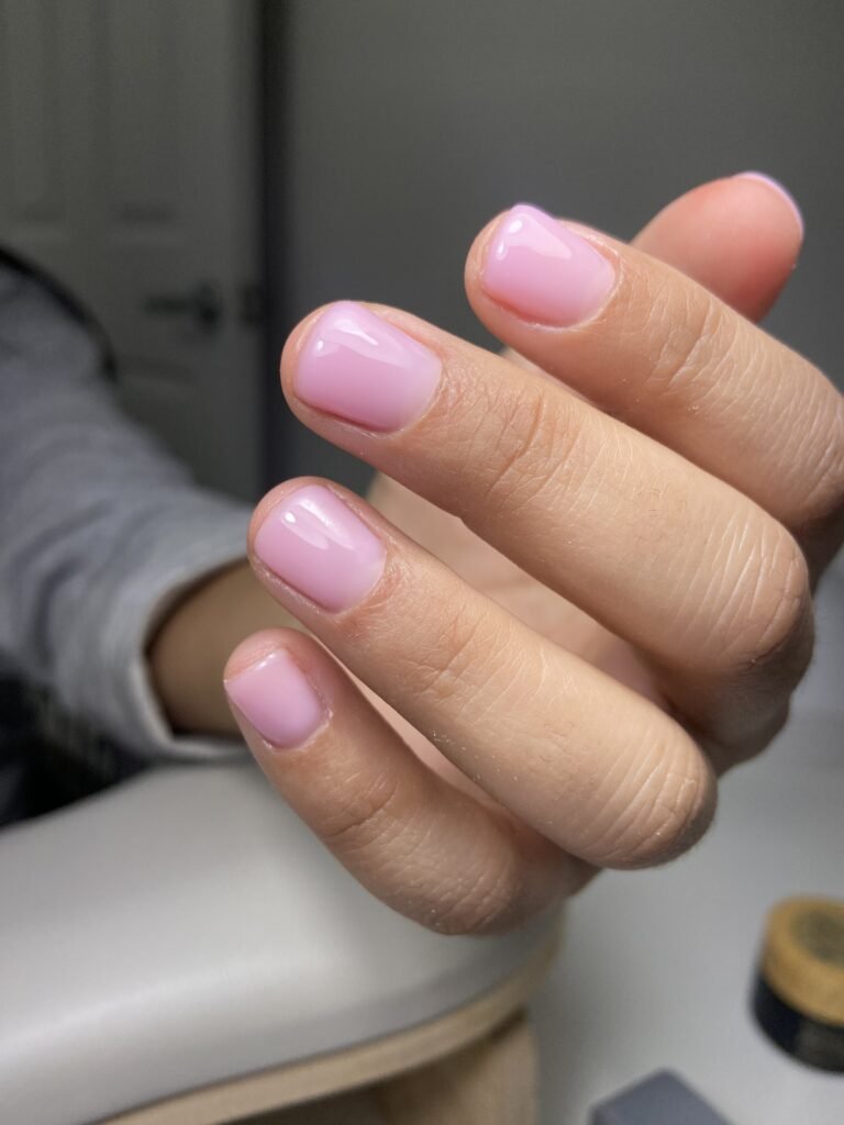 Soft pink russian nails on natural hands in Tampa Florida, clean manicure by Nail Boss Studio.