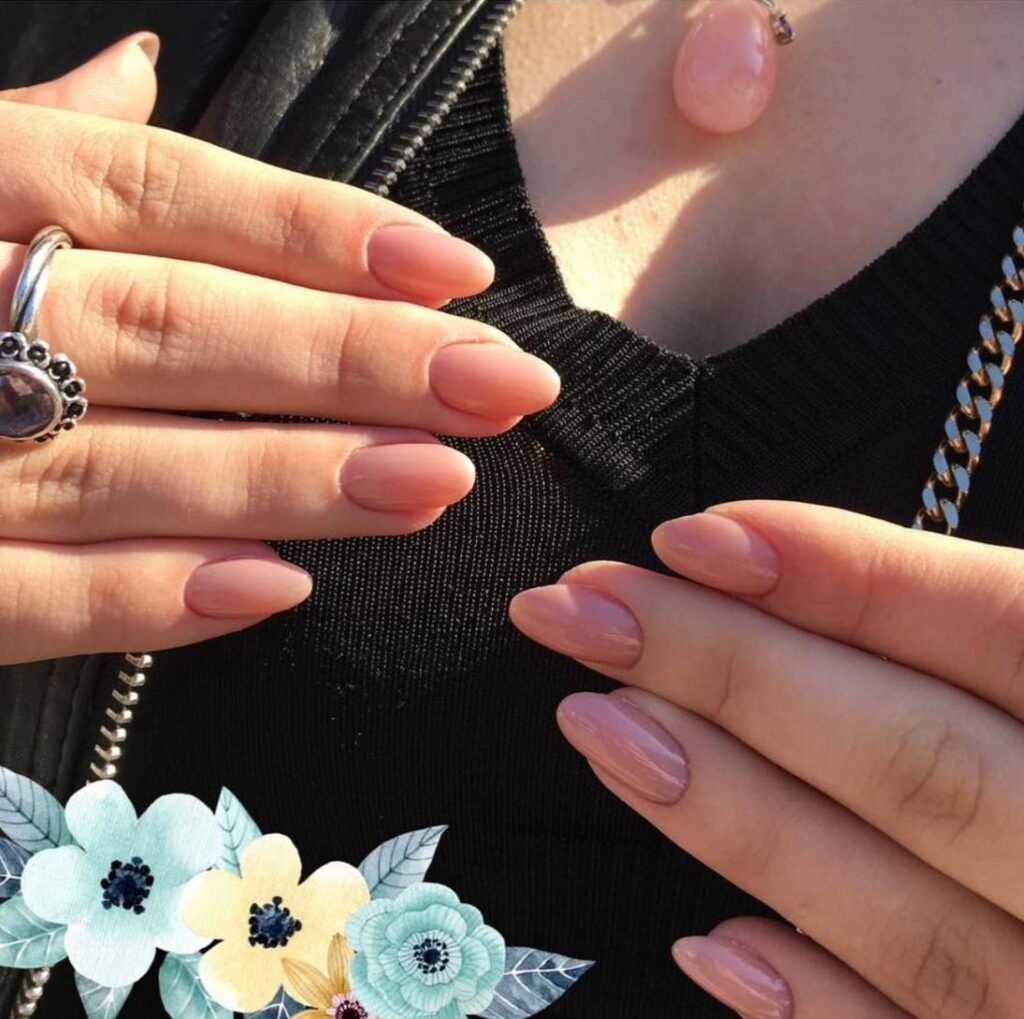 Soft nude almond manicure showcasing russian Nails Tampa precision in natural Florida sunlight, Tampa.