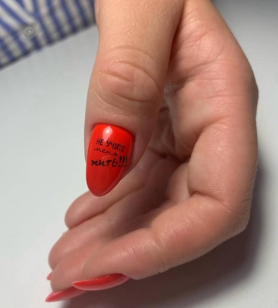 Bright red almond nail with lettering design created during a builder gel manicure in Tampa, Florida at Nail Boss Studio.