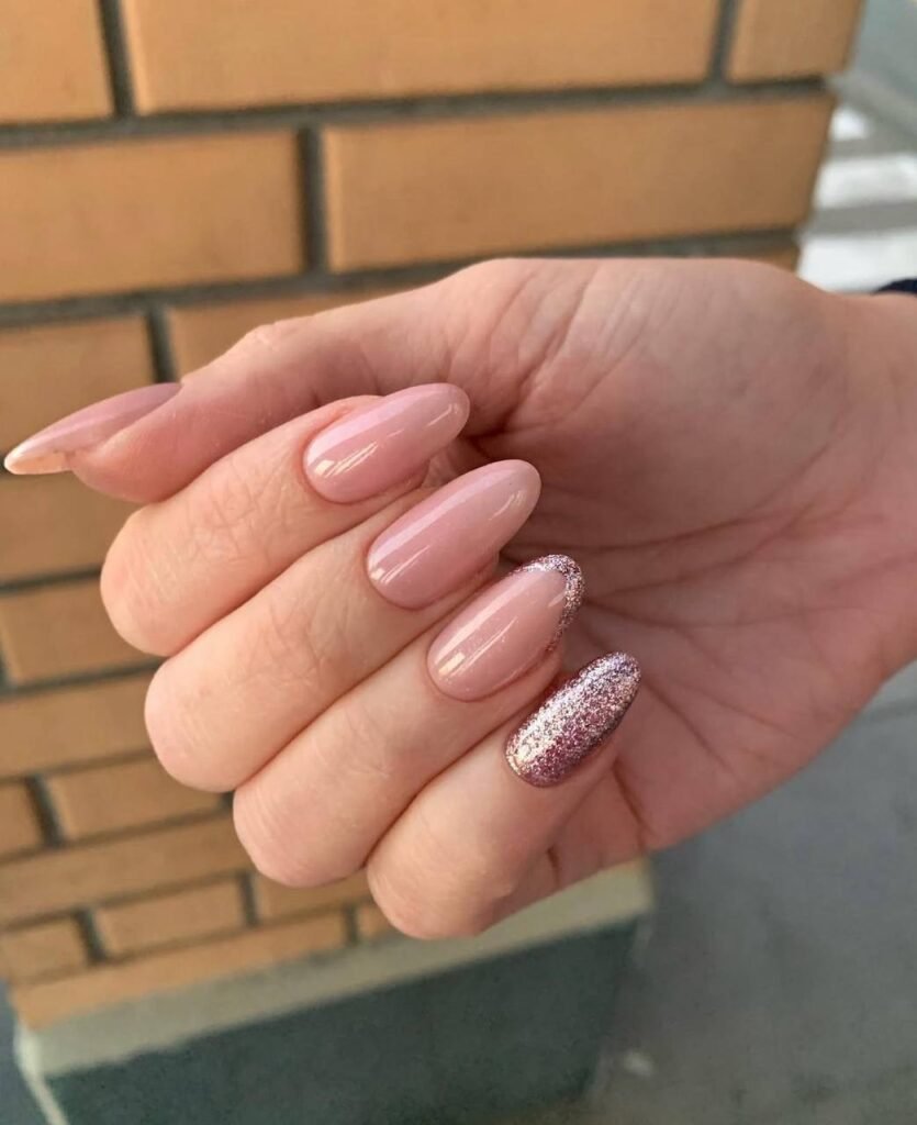 Soft glossy european manicure in nude pink tones on almond nails in Tampa Florida