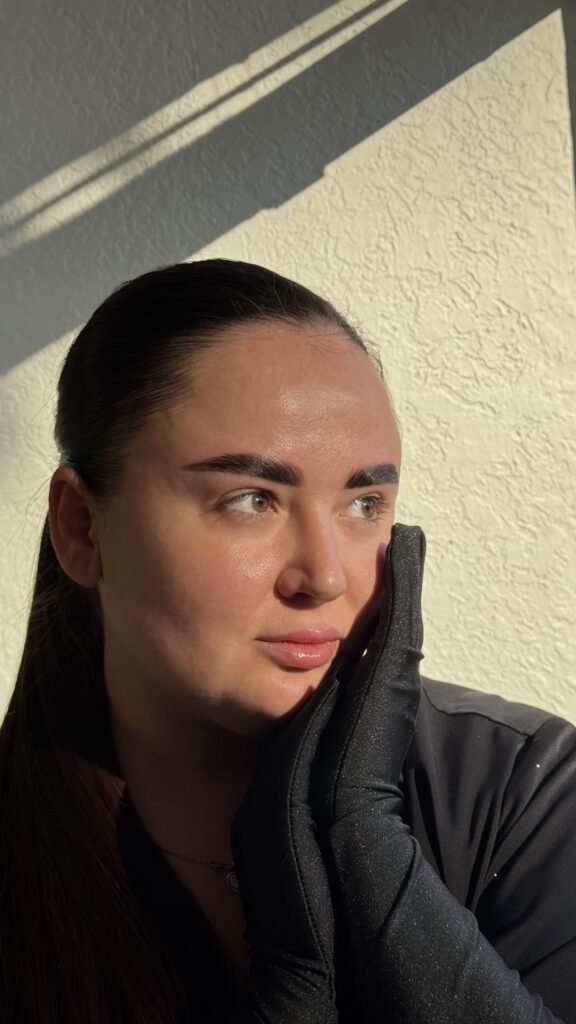 Woman with natural glowing skin and defined lashes after lash lift and tint in Tampa, Florida.