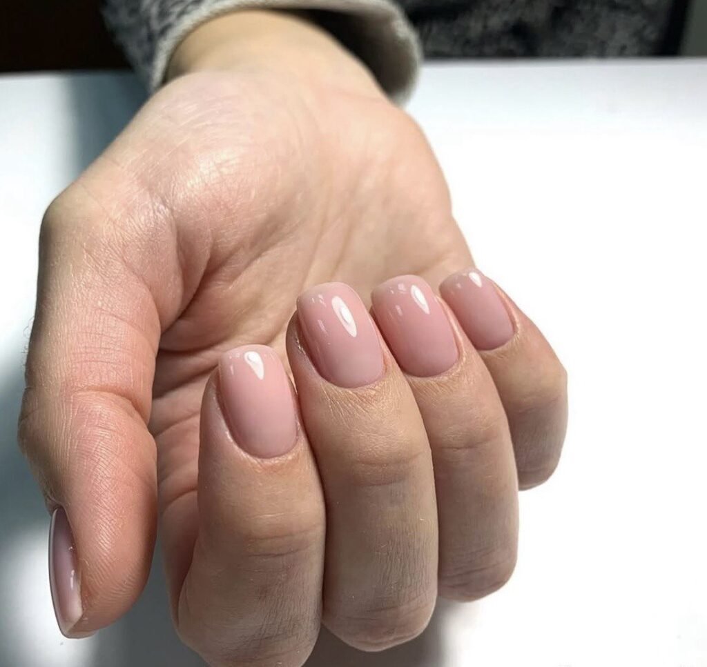 Elegant soft pink manicure from a russian nail salon near me in Tampa with clean cuticles and glossy finish