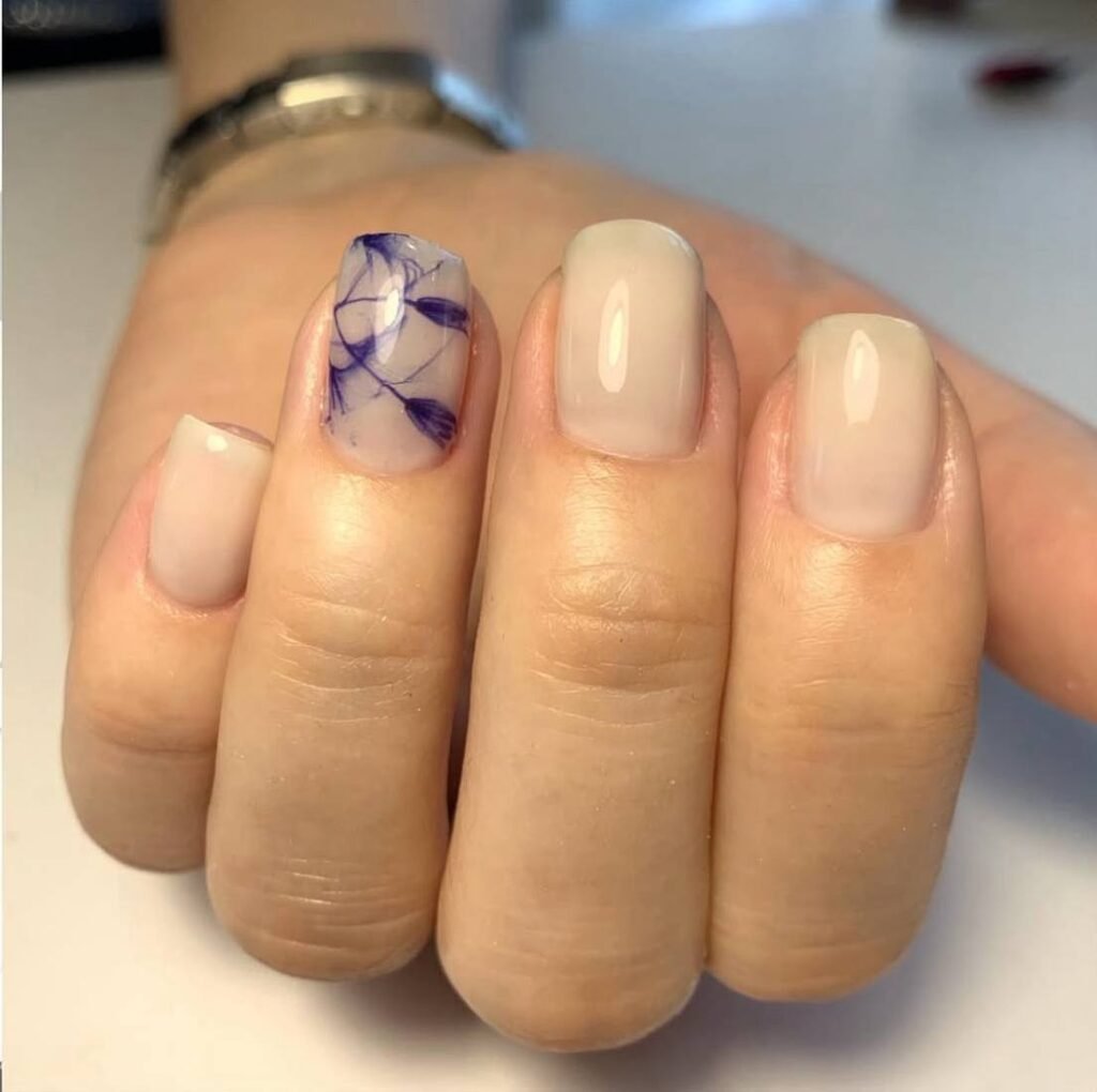 Elegant neutral manicure with floral accent created at a russian nail salon in Tampa, Florida.