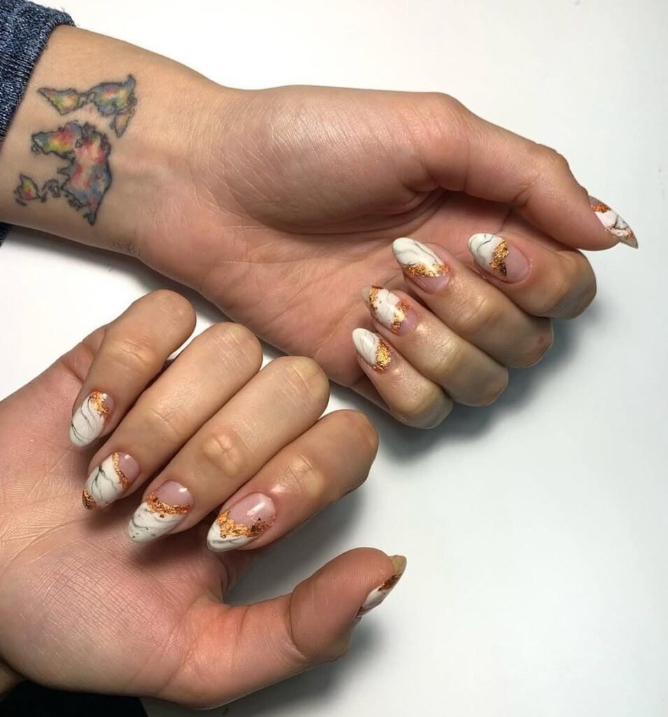Elegant soft marble manicure with gold accents at russian nail salon in Tampa Florida