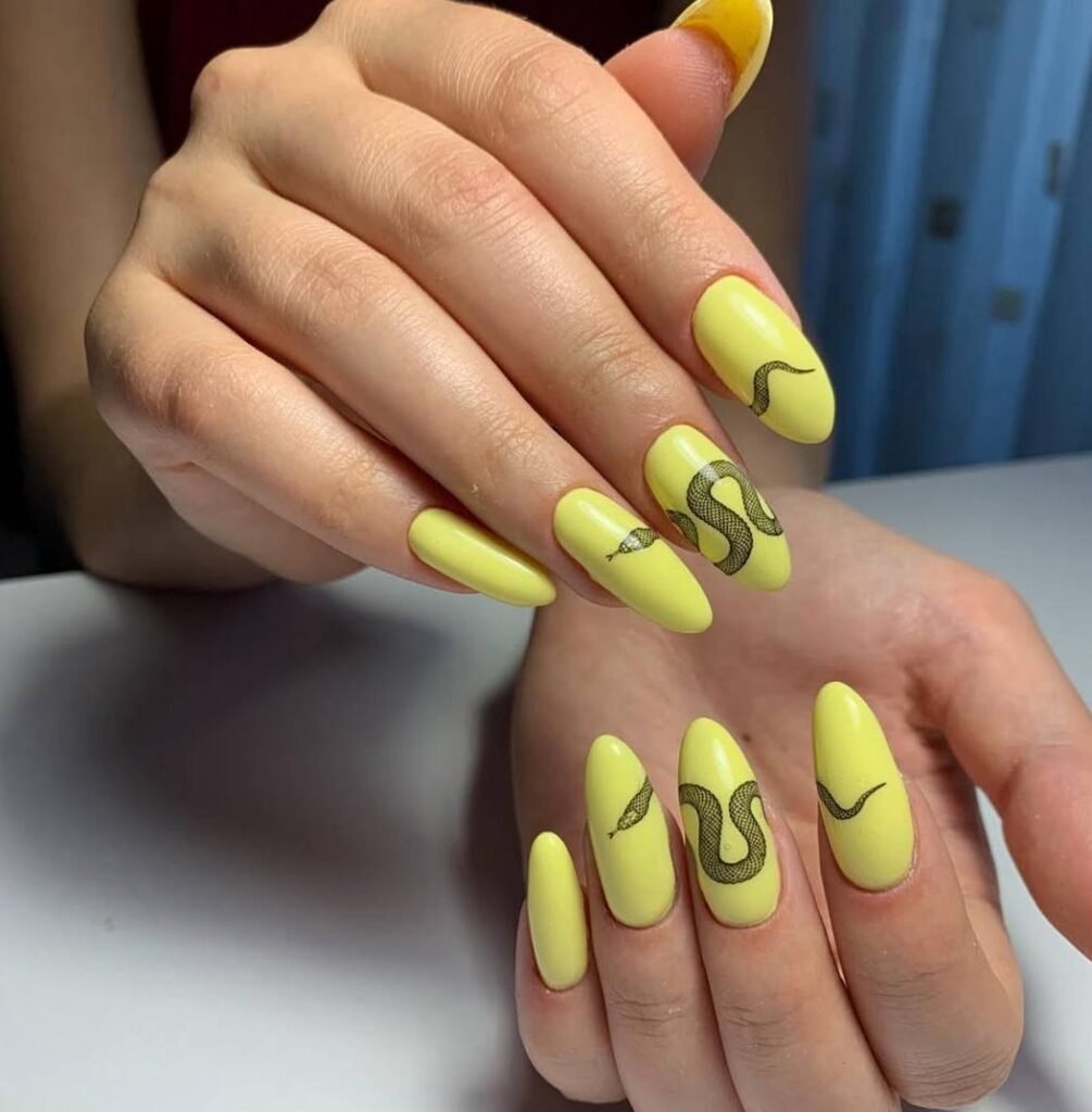 Bright yellow russian nails with snake design created at a russian manicure salon in Tampa Florida.