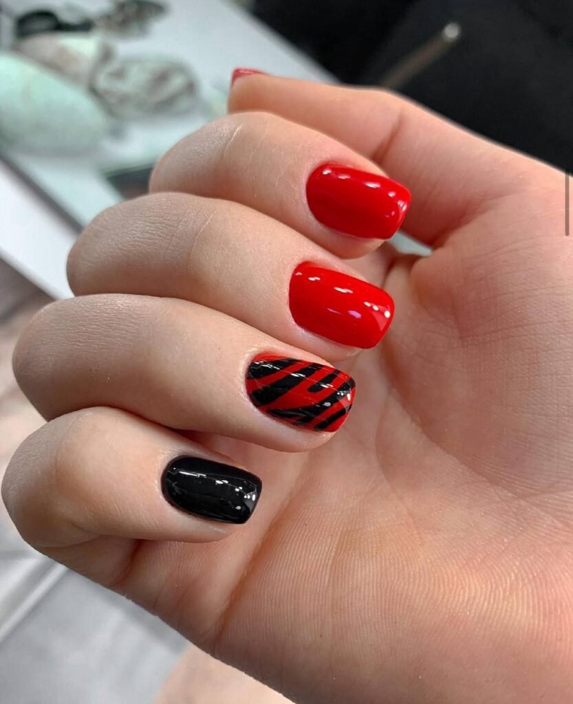 builder gel manicure Tampa with glossy red nails and black accent nail design at Nail Boss Studio