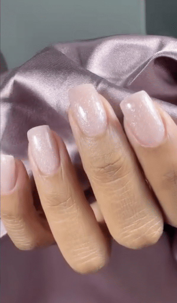 Soft pink natural nails with shimmer finish after european manicure near me in Tampa