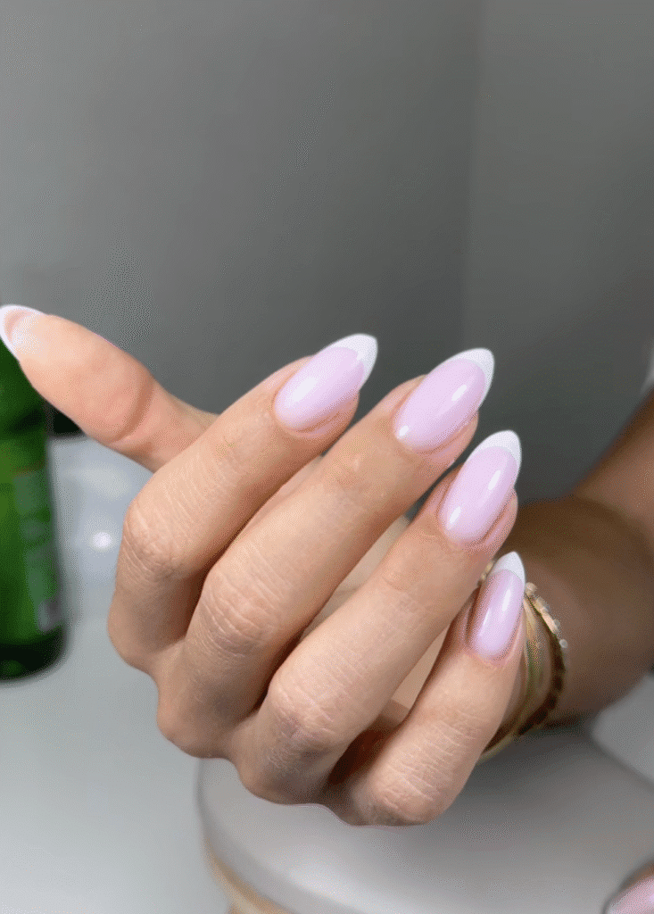 Soft pink almond-shaped nails with white tips created using hard gel russian manicure in Tampa Florida
