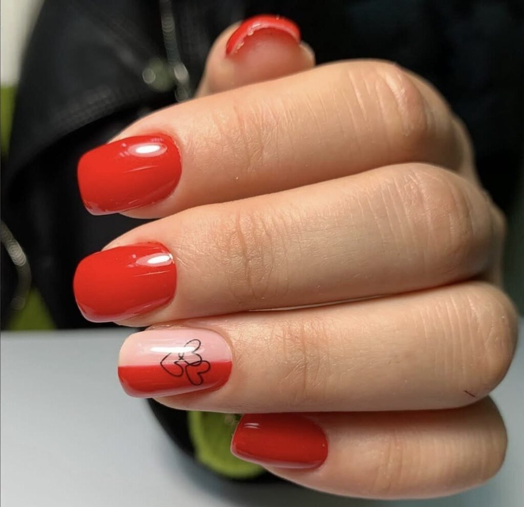 Bright red glossy nails with accent design created with russian manicure in Tampa at Nail Boss Studio