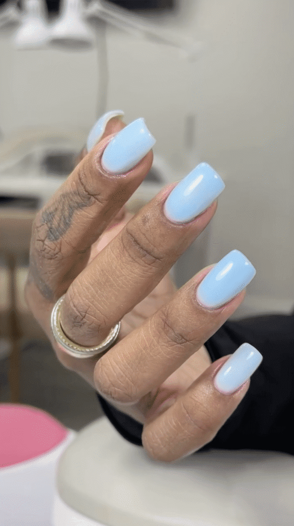 Soft blue glossy nails after russian Manicure near me in Tampa Florida with clean cuticle work