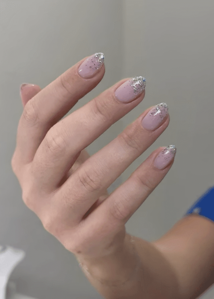 Soft pink russian manicure Tampa with delicate silver shimmer on short natural nails in Tampa Florida
