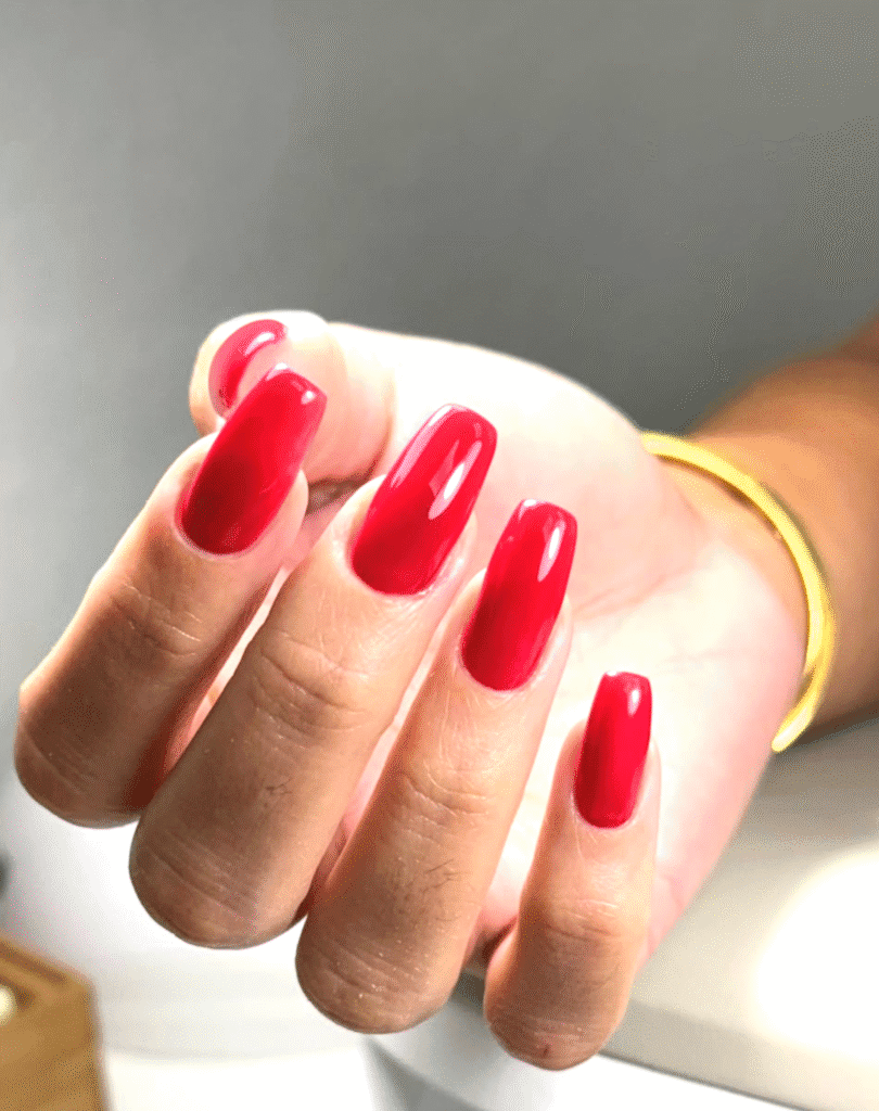 Glossy red nails with a clean finish created with russian manicures near me technique in Tampa, Florida