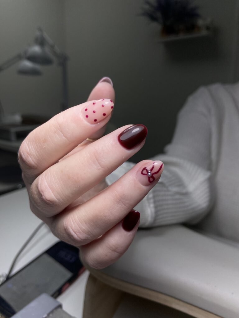 Close-up european manicure with burgundy nail design at a Tampa nail studio in Florida.