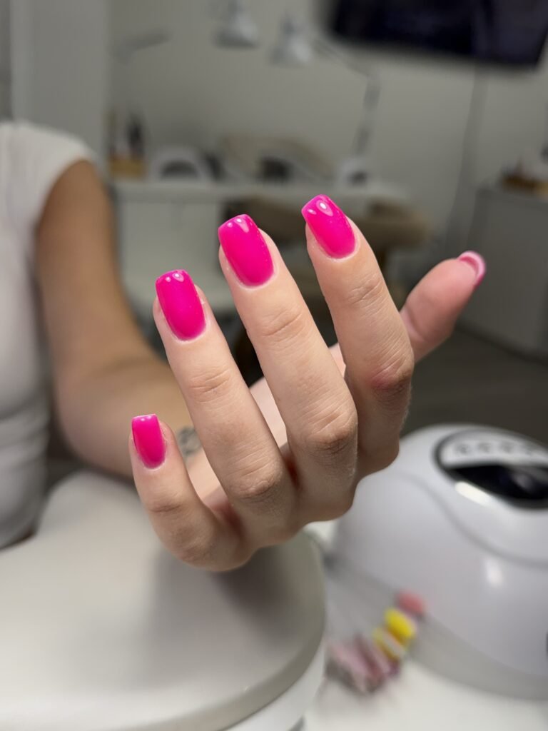 Bright pink builder gel manicure in Tampa, Florida with clean glossy European nail finish.