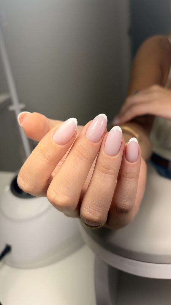 Elegant almond French nails featuring a russian manicure near me style at Nail Boss Studio Tampa, Florida.