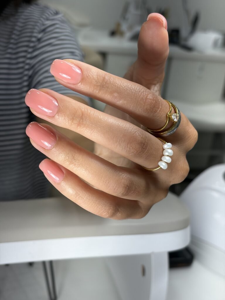 Soft pink russian manicure near me nails with glossy finish at a Tampa, Florida nail studio.