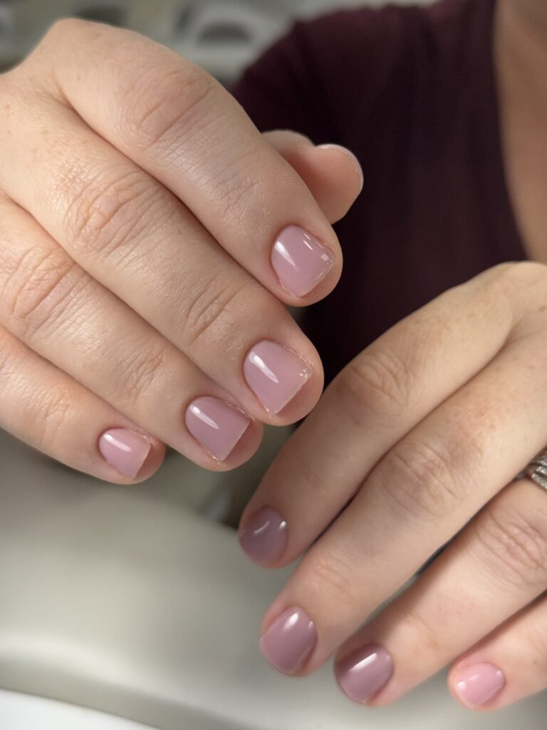 Soft pink natural nails at a russian manicure salon in Tampa, Florida with glossy dry manicure finish.