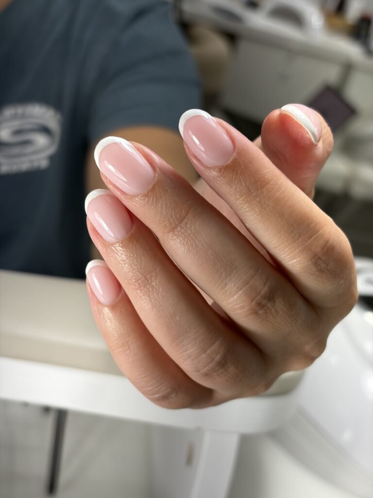 Elegant hard gel russian manicure with soft French tips and glossy natural nails in Tampa, Florida.