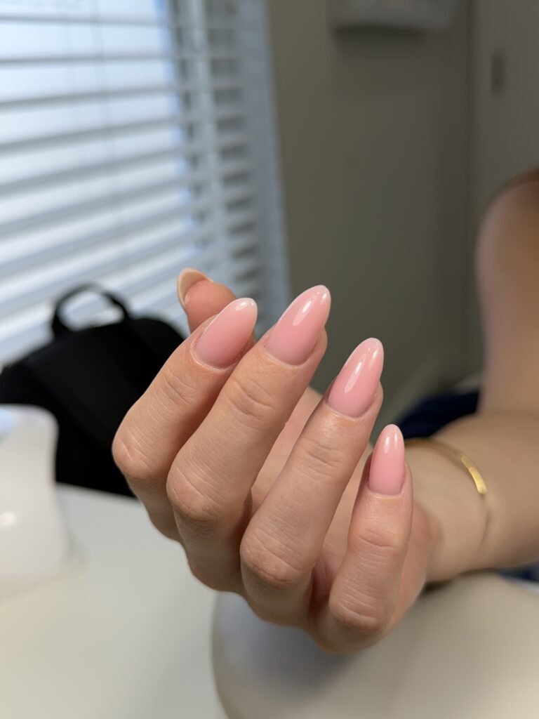 Soft pink almond nails with russian manicure near me styling at a Tampa nail studio in Florida.