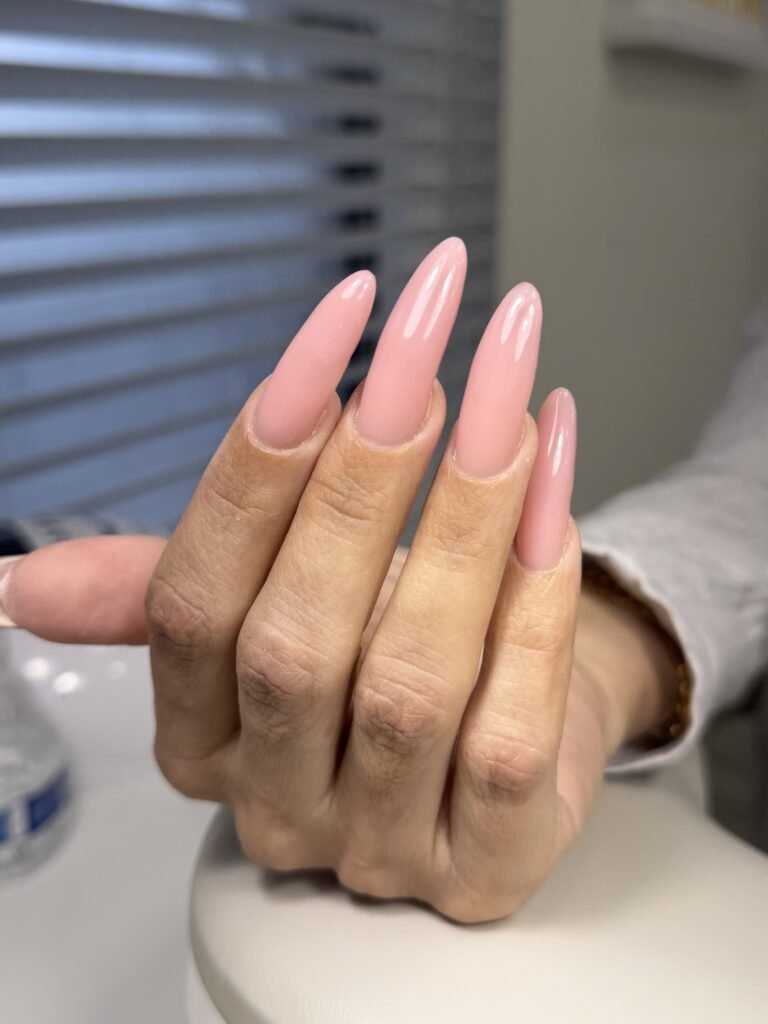 Soft pink russian nails with glossy almond shape manicure in Tampa, Florida at Nail Boss Studio.