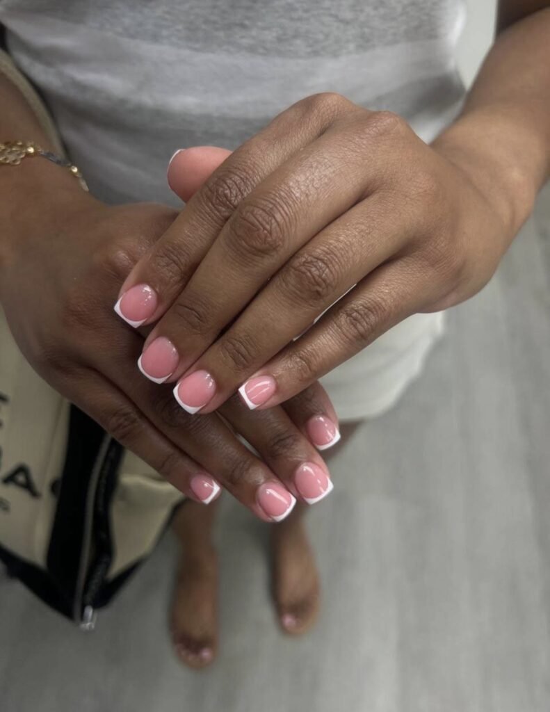 Soft pink oval nails with a glossy finish after a russian manicure near me at Nail Boss Studio Tampa, Florida.