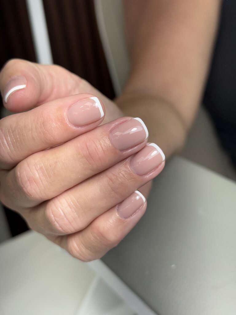 Natural French manicure with builder gel manicure near me styling and clean nude nails in Tampa, Florida.