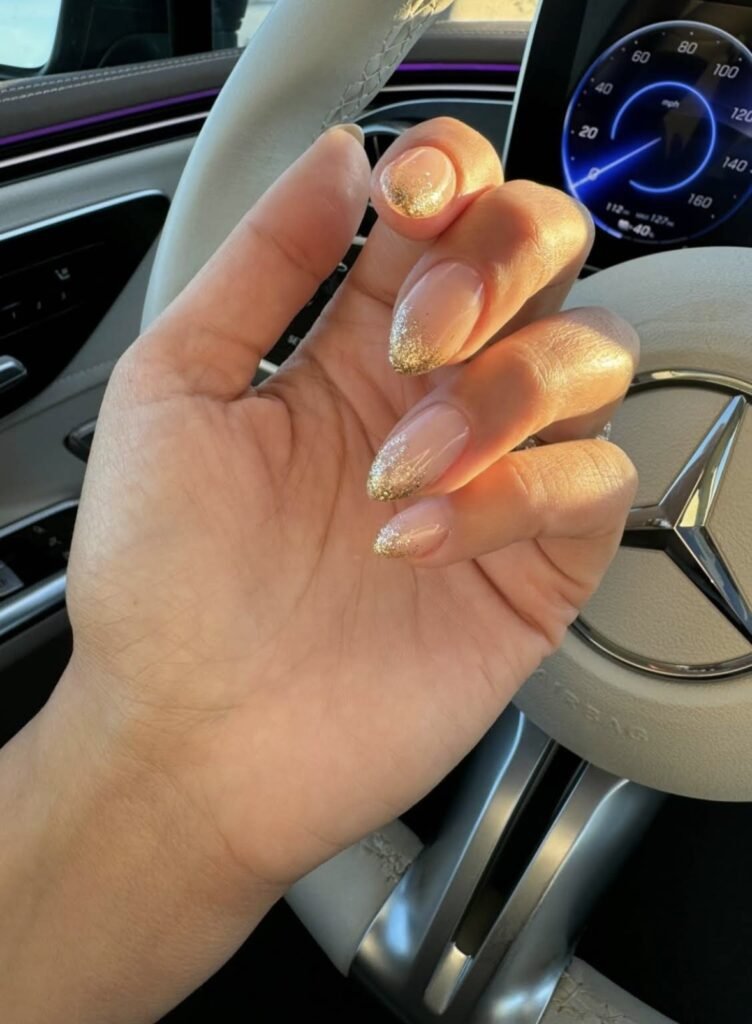 Elegant tampa russian nails with soft nude color and gold shimmer photographed during golden hour in Tampa, Florida.