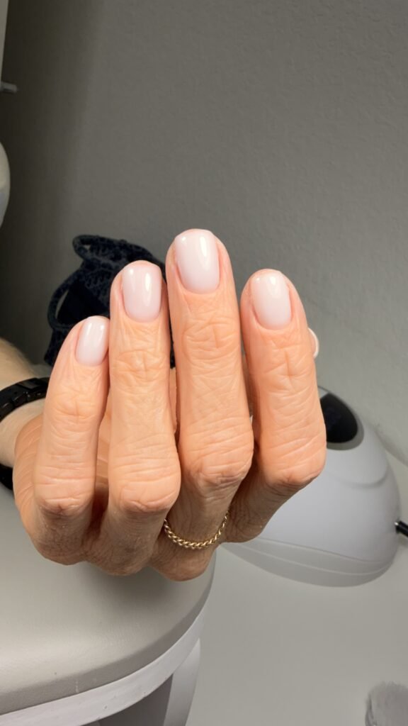 Soft milky russian nails manicure showcasing natural beauty and elegant nail care in Tampa, Florida.