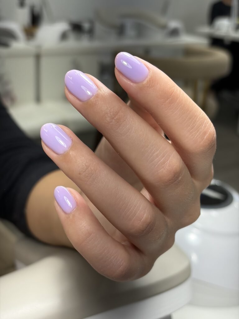 Soft lavender russian manicure Tampa on natural short nails with a glossy finish at Nail Boss Studio Tampa.