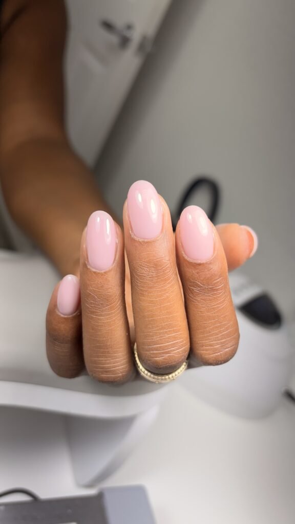 Soft blush pink tampa russian nails with a glossy finish on natural oval nails at Nail Boss Studio Tampa, Florida.