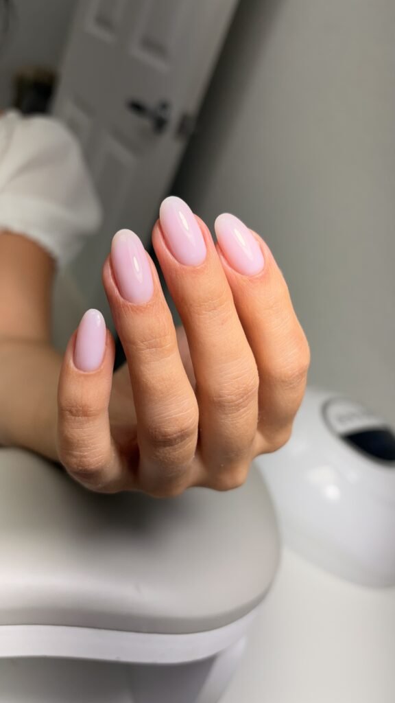 Soft pink russian manicure with clean cuticles and glossy almond nails at Nail Boss Studio in Tampa, Florida.