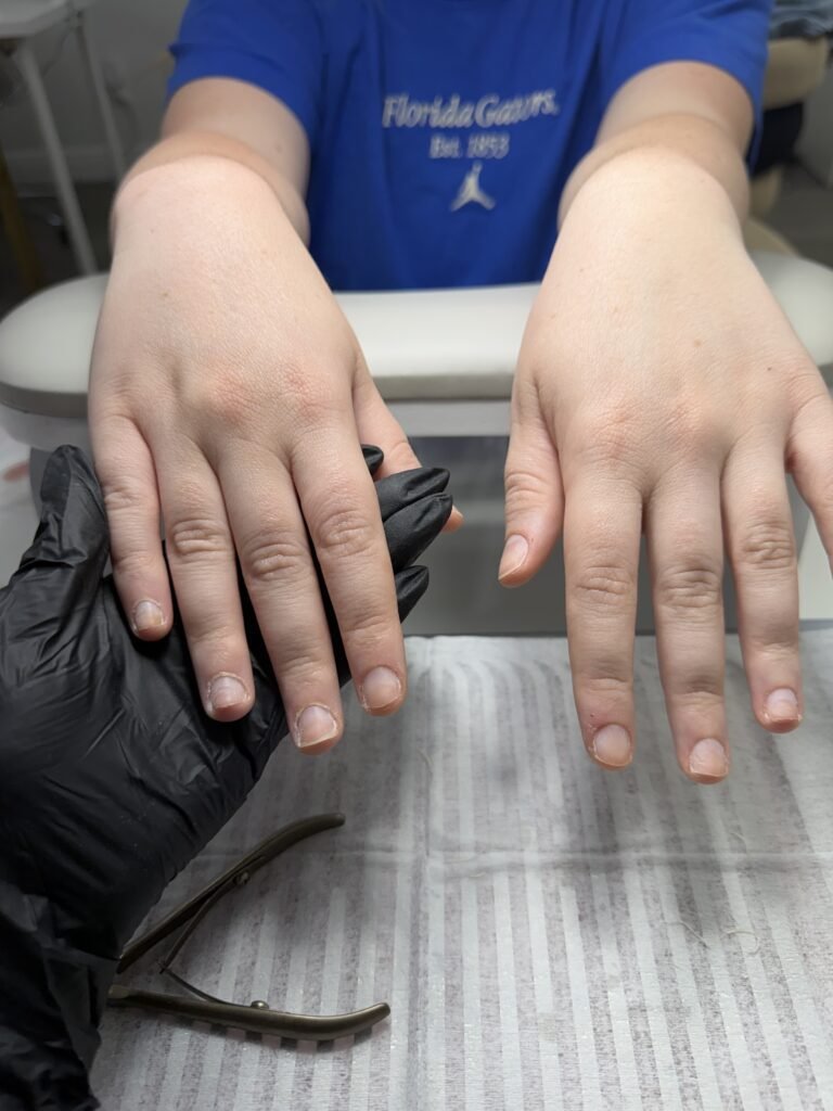 Nail technician prepping bare nails for a dry manicure at Nail Boss Studio in Tampa, Florida