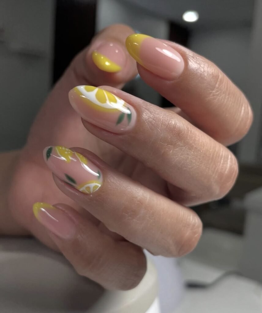 Elegant european manicure with glossy lemon French tips and citrus nail art at Nail Boss Studio Tampa, Florida.