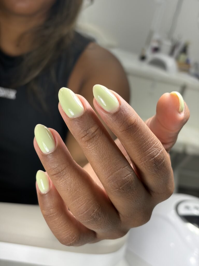 Soft pastel green tampa russian nails with a glossy almond shape manicure at Nail Boss Studio Tampa, Florida.
