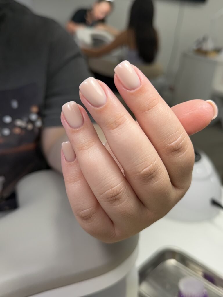 Close-up of beige russian manicure near me finished at Nail Boss Studio Tampa