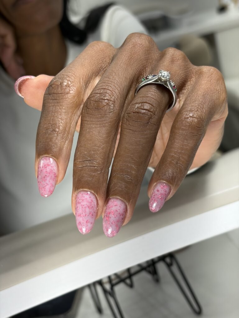 Soft pink russian manicure with delicate shimmer on natural almond nails at Nail Boss Studio Tampa, Florida.