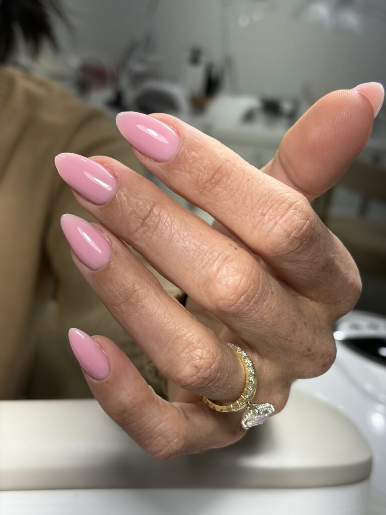 Elegant soft pink almond-shaped dry manicure at Nail Boss Studio Tampa, Florida with flawless glossy finish.