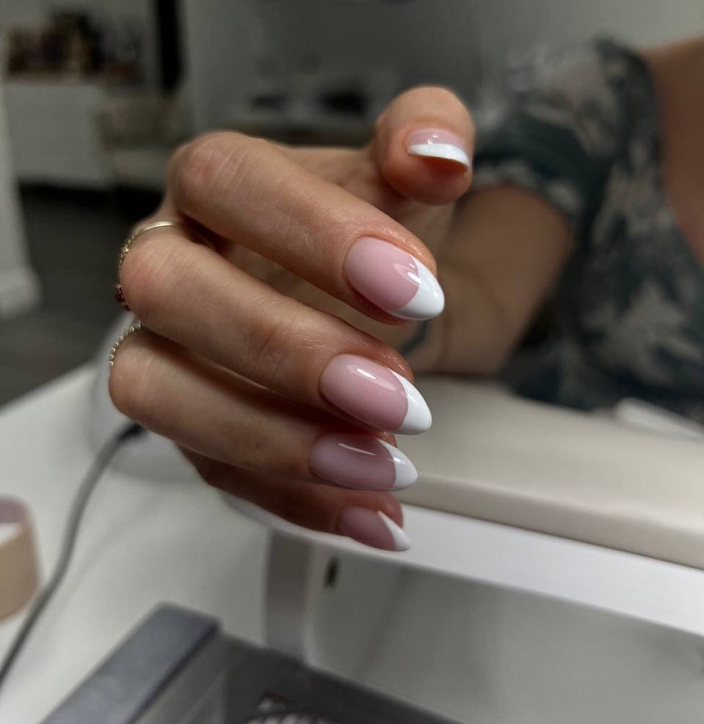 Elegant french manicure with almond-shaped tampa russian nails at Nail Boss Studio Tampa, Florida.