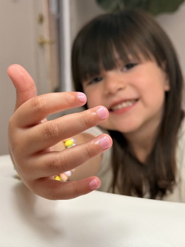Child showing a soft pink russian manicure in tampa with clean natural nails at Nail Boss Studio Tampa.