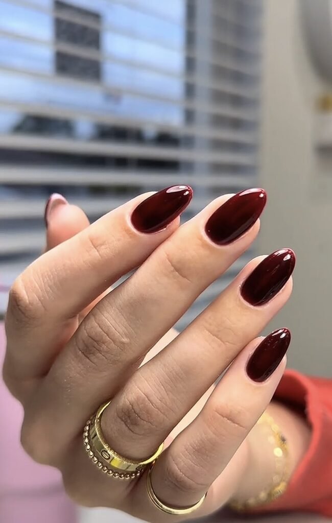 Elegant burgundy almond nails showcasing russian manicures near me at Nail Boss Studio Tampa, Florida.