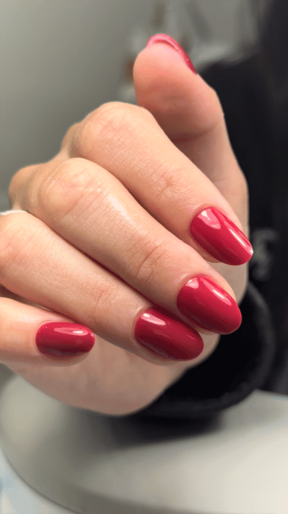 Glossy cherry red oval nails, a builder gel manicure style reference for Nail Boss Studio in Tampa.
