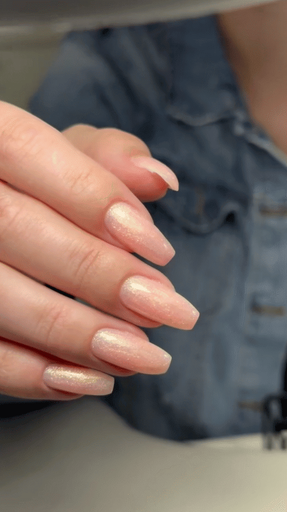 Soft pink tapered nails with gold shimmer, inspiration for european manicure near me in Tampa.