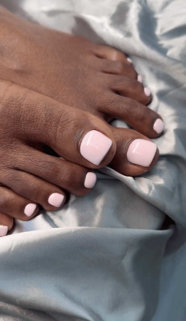 gel pedicure Tampa featuring soft pink toenails with crisp white French tips and a glossy finish at Nail Boss Studio.