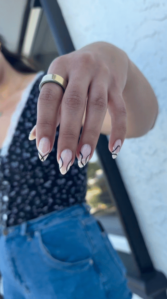 Pale pink shimmer russian manicure with almond nails and black and white abstract lines in Tampa.