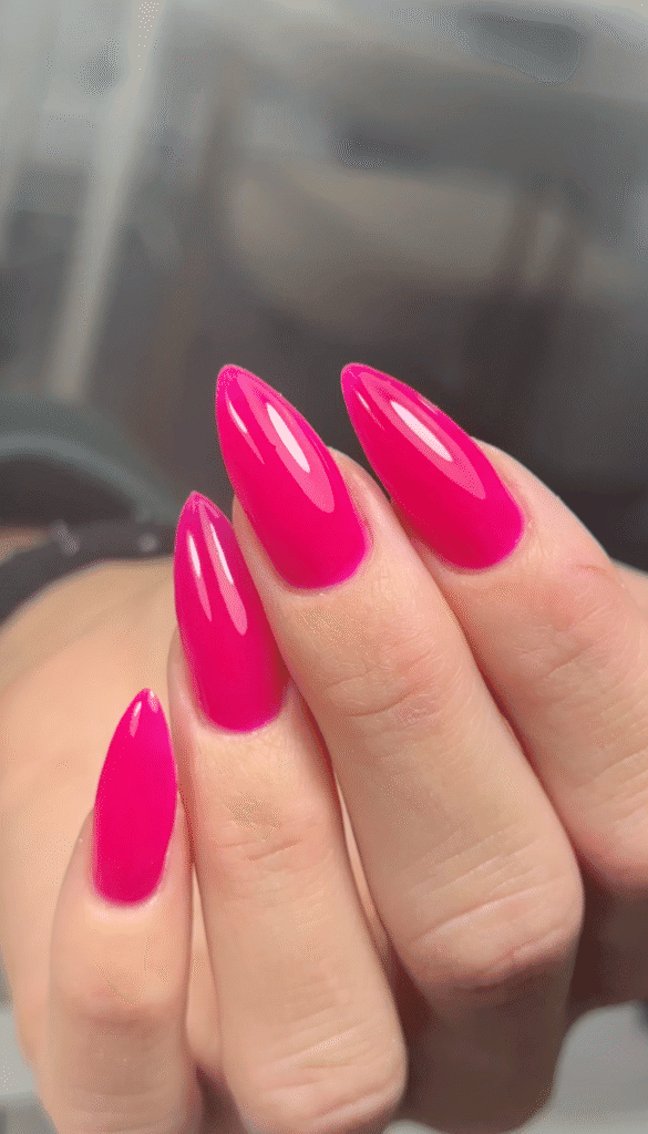 Glossy hot pink almond-shaped russian nails tampa manicure with a smooth fuchsia finish at Nail Boss Studio in Tampa, Florida.
