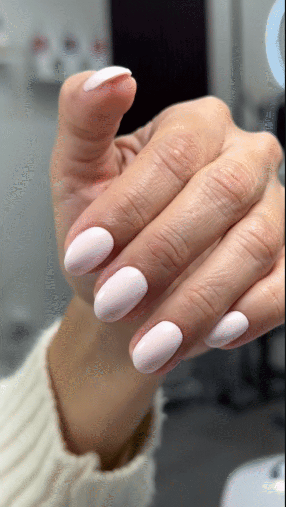 Soft pink almond-shaped nails with a glossy finish, featuring an elegant russian manicure at Nail Boss Studio Tampa.