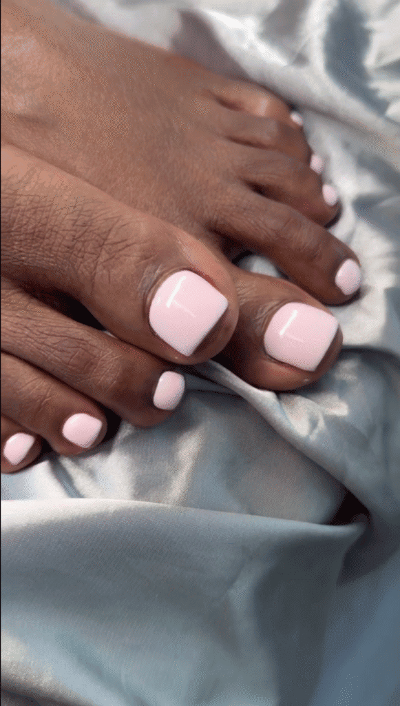 Glossy blush pink toenails with soft square edges on silver satin, showcasing tampa smart pedicure inspiration in Tampa.